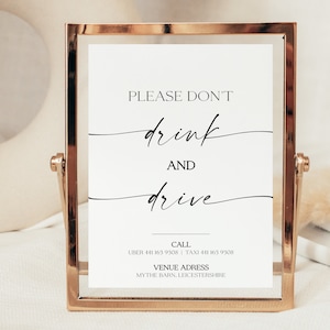 May include: A gold-framed sign with the text "PLEASE DON'T drink AND drive" in black calligraphy. The sign also includes contact information for Uber and Taxi services, as well as the venue address: "MYTHE BARN, LEICESTERSHIRE."