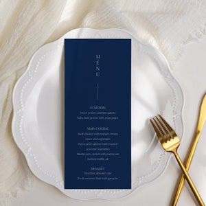May include: A navy blue menu card with white text. The menu includes starters, main course, and dessert options. The text reads: "MENU", "STARTERS", "Sweet potato and brie palette, baby field greens with asian pear", "MAIN COURSE", "Hard chicken with tomato cream sauce and asparagus", "Pan-seared salmon with roasted seasonal vegetables", "Mushrooms ravioli with parmesan, herbed truffle oil", "DESSERT", "Hazelnut almond cake, fresh summer fruit with ganache".