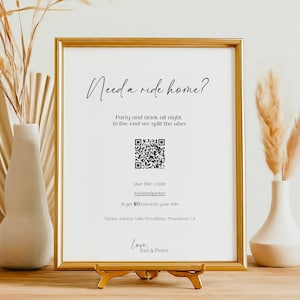May include: A framed sign with the text "Need a ride home?" and a QR code. The text below the QR code reads "use the code Lordondpeter & get $15 towards your ride Venue Address: Villa Woodbine, Pasadena CA Love, Torl & Peter"