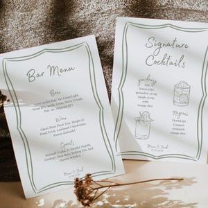 May include: Two white paper menus with a decorative border. One reads "Bar Menu" and lists beer, wine, and spirits. The other says "Signature Cocktails" and details two drink recipes. Both menus have handwritten text.