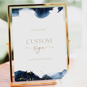 May include: A gold-framed sign with a white background and blue and gold watercolor design. The text on the sign reads "FULLY EDITABLE CUSTOM Sign Design & Print Unlimited Signs".