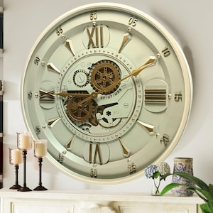 May include: A large, white and gold wall clock with Roman numeral markings and a detailed gear design. The clock face is light green and the hands are gold. The clock reads "SPINTIMES".
