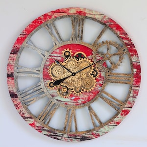 May include: A large, round, red and gold clock with Roman numeral markings and a detailed gear design. The clock face is surrounded by a distressed wood-like frame.