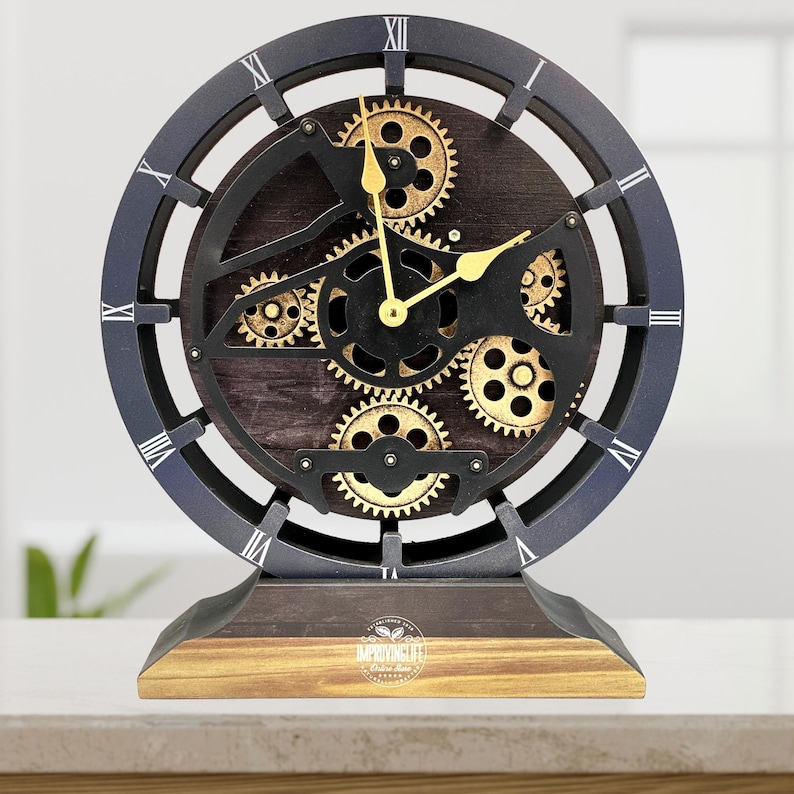 May include: A black and gold clock with a gear design. The clock has Roman numerals and is on a wooden base.