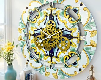 May include: A round wall clock featuring a white background with yellow and light green floral patterns. The clock face displays black Roman numerals and a central mechanism of exposed gold-colored gears. The text Proano is printed near the top.