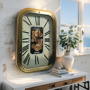 May include: A rectangular wall clock with a gold-colored frame and black Roman numerals. The clock face has a distressed, vintage look with a central panel featuring gears and the text "Old Town Clock London".