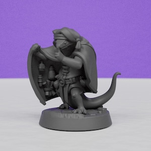 May include: A gray figurine of a lizard-like creature wearing a hooded cloak and holding a shield. The shield has hanging lanterns. The creature is standing on a round base with a purple background.