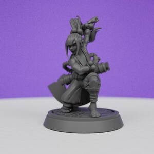 May include: A grey plastic miniature figurine of a female warrior with a weapon and a ponytail. The figurine is standing on a round base.