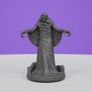 May include: A gray figurine of a vampire with outstretched arms and sharp claws. The vampire wears a long coat and stands on a detailed base. The figure has a menacing expression, with sharp teeth and pointed ears. The background is a solid purple.