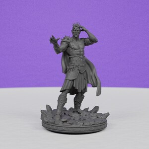 May include: A gray figurine of a muscular figure with a crown, cape, and armor. The figure is standing on a rocky base, with one hand raised and the other touching its head. The background is a solid purple.