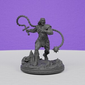 May include: A gray figurine of a muscular warrior with long hair, wielding a flail. The figure is on a detailed base with a rocky terrain. The warrior is in a dynamic pose, with an open mouth, suggesting a battle cry. The background is a solid purple.