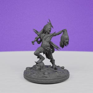 May include: A gray figurine of a fantasy warrior holding a severed head and a weapon. The warrior stands on a base with a sculpted face. The figure has multiple arms and is wearing armor.