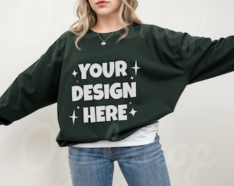May include: A dark green long-sleeved sweatshirt with the text "YOUR DESIGN HERE" in white lettering and small white stars.