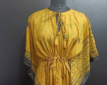 May include: A yellow kaftan with black floral print and a drawstring waist. The kaftan has a V-neck and short sleeves.