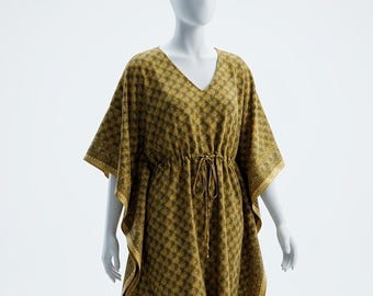 May include: An olive green kaftan dress with a V-neck and drawstring waist. The dress has a repeating geometric pattern in a lighter green and gold. The sleeves and hem are trimmed with a gold border. The dress is approximately 140 cm in length.