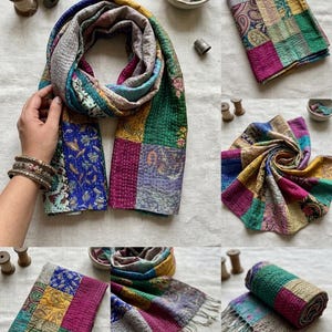 May include: A patchwork scarf featuring various colorful fabric squares with intricate floral and paisley patterns. The scarf is constructed with visible running stitch quilting and includes sections in shades of blue, green, yellow, and magenta.
