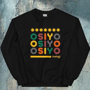 May include: Black sweatshirt with a graphic design featuring the word "OSIYO" repeated three times in a colorful retro style. The word is surrounded by yellow stars and a yellow line with the word "tsalagi" below it.