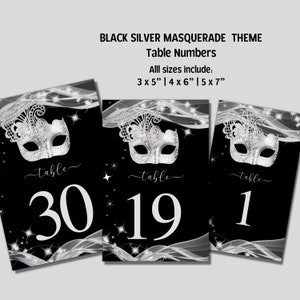 May include: Three black and silver table number cards with a silver masquerade mask design. The table numbers are 30, 19, and 1. The text "Table" is written in cursive above each number. The text "Black Silver Masquerade Theme Table Numbers" is at the top of the image. The text "All sizes include: 3 x 5" | 4 x 6" | 5 x 7" is below the title.