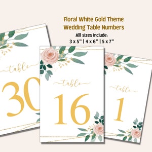 May include: Three white table number cards with gold glitter accents and floral designs. The numbers are 30, 16, and 1. The text "table" is written in cursive on each card. All sizes include: 3 x 5", 4 x 6", 5 x 7".