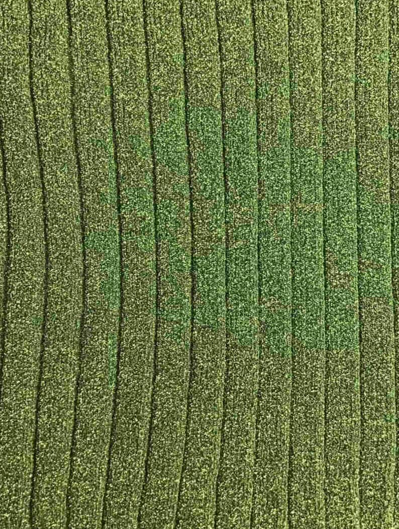 May include: A close-up of a green ribbed fabric with a subtle shimmer. The fabric has a textured, woven appearance.