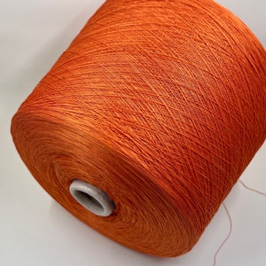 Peut inclure: Une bobine de fil orange, enroulée serrée et prête pour le tricot ou le crochet.
