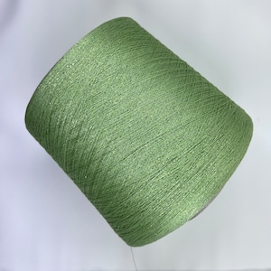 May include: A spool of green yarn with a shimmery finish.