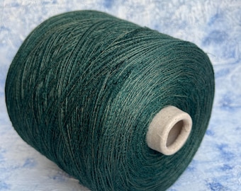 May include: A spool of dark green yarn.
