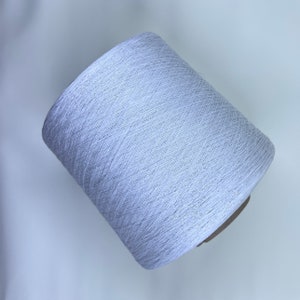 May include: A spool of white yarn with a subtle shimmer.