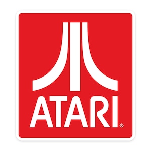 May include: Square sticker featuring the Atari logo. The logo is a stylized white design on a red background, with the word "ATARI" in white letters below. The sticker has a white border.