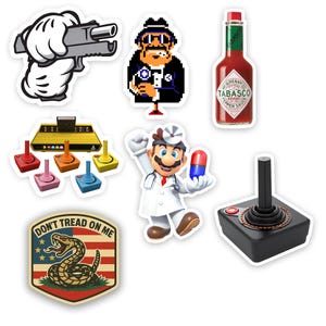 May include: A collection of stickers featuring various designs. Included are a cartoon hand holding a gun, an 8-bit pixelated character, a bottle of Tabasco sauce, a retro video game console with colorful joysticks, a Mario-themed doctor, a joystick, and a "Don't Tread on Me" emblem.
