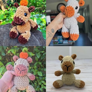 May include: A collection of four handmade crochet plush toys shaped like camels. Each camel features a soft, textured yarn body in shades of tan, brown, or white, with dark plastic eyes and a small orange or green crocheted pumpkin on its head.