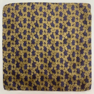 May include: A square patterned fabric with a repeating design of gold leaves and small pink dots on a dark blue background.