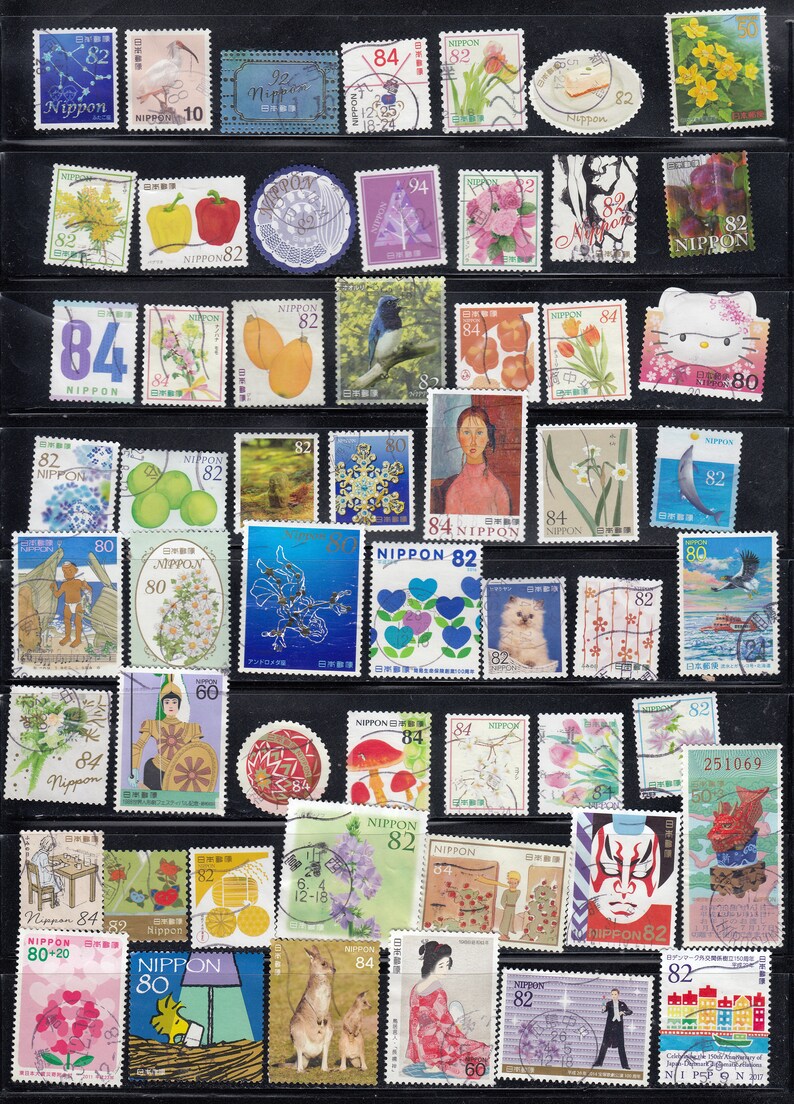 Puede incluir: Una colecci&oacute;n de sellos postales japoneses antiguos, con varios dise&ntilde;os que incluyen flores, animales, retratos y arte abstracto. Los sellos son de varios colores y tama&ntilde;os, con la palabra "Nippon" visible en muchos.