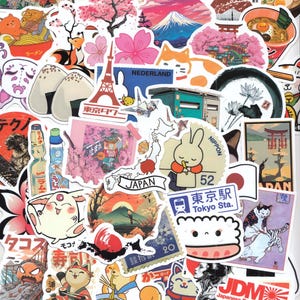 May include: A selection of vibrant Japanese-themed stickers. The designs include Mount Fuji, cherry blossoms, ramen, cats, and Japanese text. Some stickers feature the text "TOKYO", "JAPAN", and "Tokyo Sta."