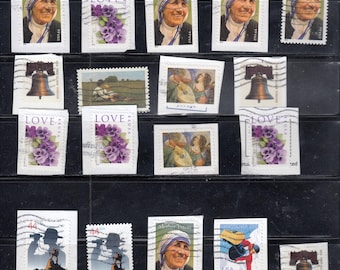 May include: A selection of vintage postage stamps with diverse designs. Stamps depict Mother Teresa, floral arrangements with the word "LOVE", a bell, and images related to scouting and the Olympics. The stamps are displayed against a black backdrop.