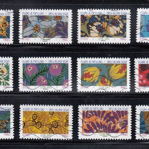 May include: Twelve vintage French postage stamps featuring colorful floral and butterfly designs. The stamps are arranged in three rows of four. Each stamp has the text "FLEURS & PAPILLONS" and "MILE-ALLAIN SEGUY" printed on it.