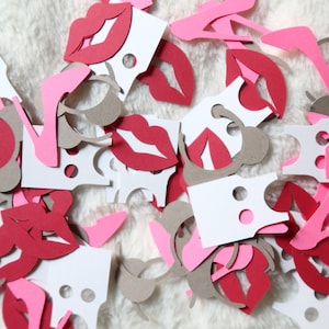 May include: A pile of confetti featuring pink, red, and brown paper cutouts of lips, high heels, and blank tags.