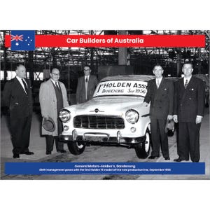 May include: Black and white photo of a group of men standing in front of a white car. The car has a sign on the windshield that reads "Holden Assy Dandenong Sept 1956".