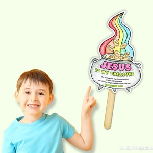 May include: A colorful illustration of a pot of gold with a rainbow above it, and the text "JESUS IS MY TREASURE". The illustration is held by a wooden stick. The image also includes the text "Matthew 6:33".