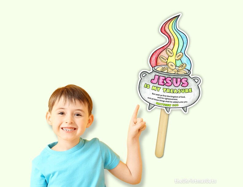 May include: A colorful illustration of a pot of gold with a rainbow above it, and the text "JESUS IS MY TREASURE". The illustration is held by a wooden stick. The image also includes the text "Matthew 6:33".