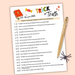 May include: A white paper with the text "Trick or Truth" and "Use your Bible" with a game format. A gold pen and a black spider decoration are on the right side. The game is about fact or fiction.