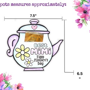 May include: A light blue teapot with a pink lid and handle. The teapot has a yellow daisy design and the words "Best Mimi" and "Happy Mother's Day". The teapot is 7.5 inches tall and 6.5 inches wide.