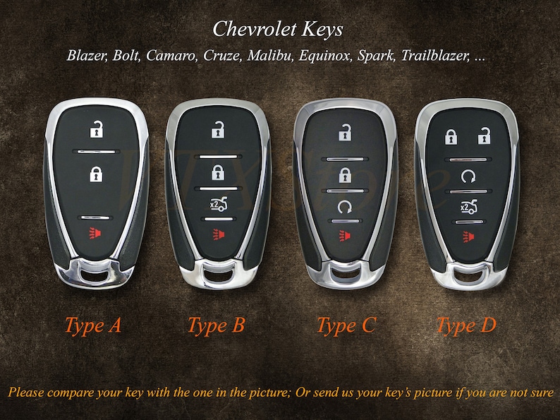 May include: Four different types of Chevrolet car keys, labelled A, B, C, and D. Each key has a black plastic case with silver trim and a red button. The keys have different button arrangements.