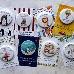 May include: A set of 10 personalized thank you cards with round buttons featuring various animal illustrations. The cards are decorated with different themes, including mountains, stripes, jungle animals, hot air balloons, and rockets. Each card includes a personalized message thanking guests for celebrating with the birthday child.