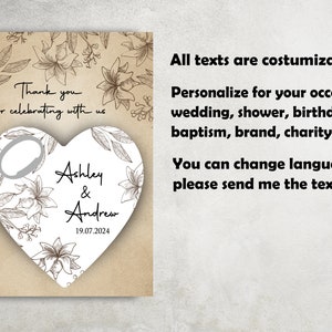 May include: A heart-shaped bottle opener with a floral design and the text "Thank you for celebrating with us Ashley & Andrew 19.07.2024".