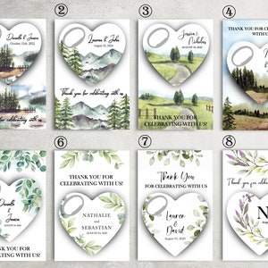 May include: Ten different wedding favor tags with a heart-shaped design. Each tag features a watercolor illustration of a forest scene with a ring pull bottle opener. The tags include the names of the couples and their wedding dates.