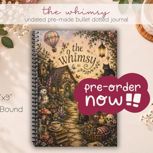 May include: A 6"x9" coil bound bullet dotted journal titled the whimsy. The cover features a detailed illustration of a cottage, a hot air balloon, a black cat, a snowman, a skull, and a teacup on a stone path. A maroon graphic says pre-order now!!
