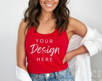 Puede incluir: Una mujer lleva una camiseta de tirantes roja con el texto "YOUR Design HERE" en blanco. Lleva pantalones vaqueros azules y una camisa blanca sobre los hombros.