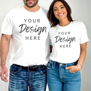 May include: A white t-shirt with the text "YOUR Design HERE" on the front. A white t-shirt with the text "YOUR Design HERE" on the front.