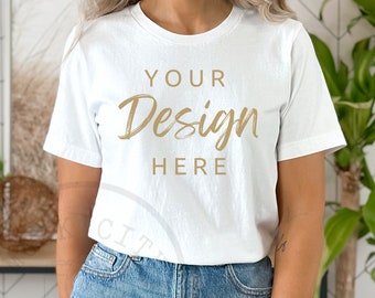 May include: A white t-shirt with the text "YOUR Design HERE" in gold lettering.